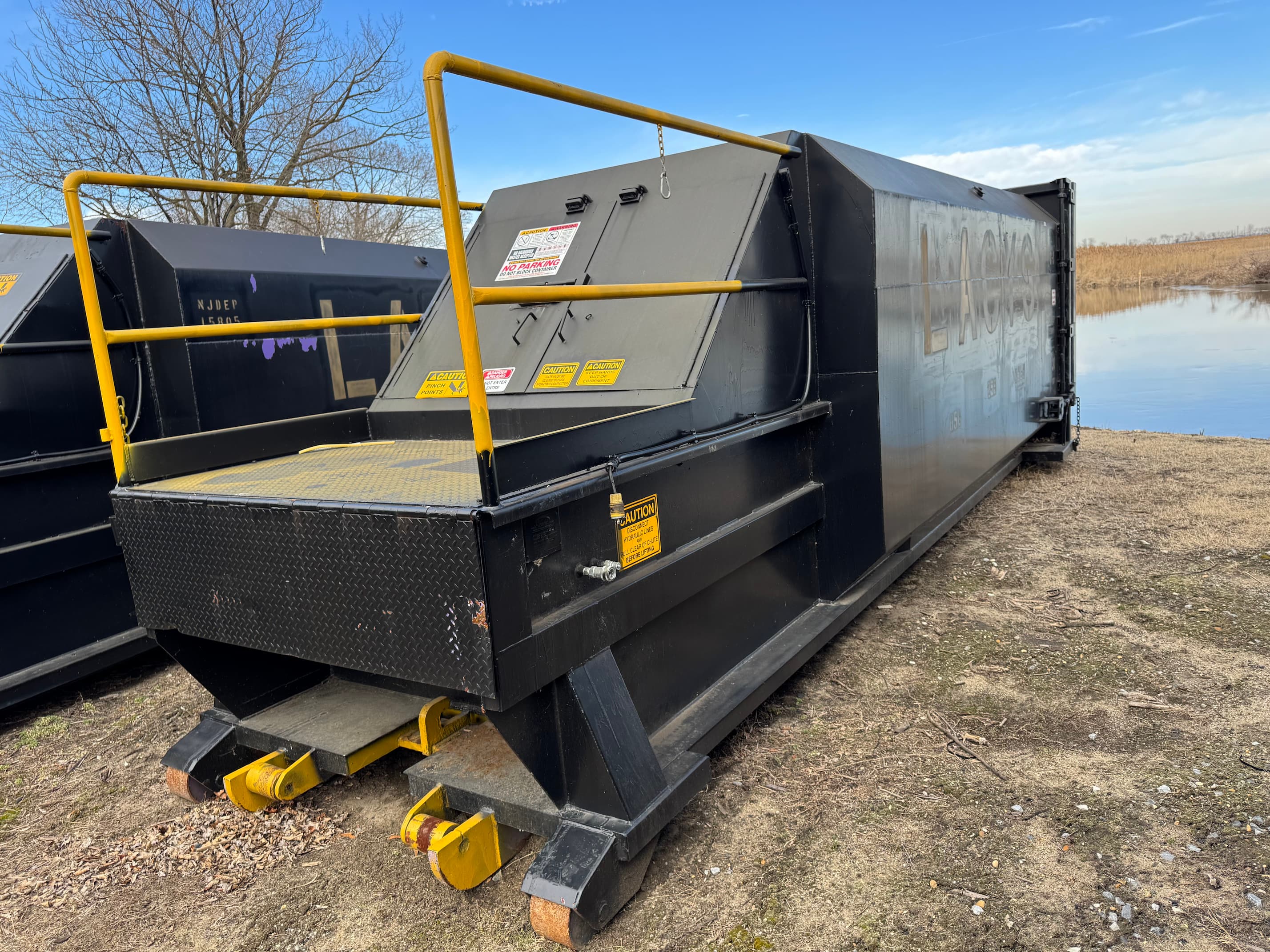 A black trash compactor.